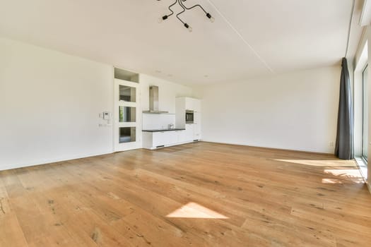 An open, airy living area featuring minimal decor and wooden flooring, ideal for contemporary living and design inspiration.