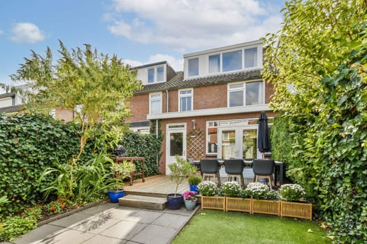 A beautifully designed backyard featuring vibrant plants, a cozy seating area, and a stone pathway creates a serene outdoor environment perfect for relaxation.
