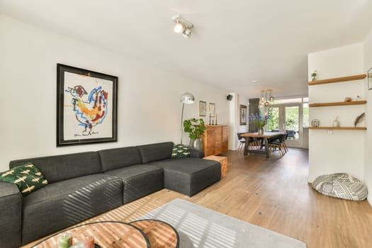A stylish modern living room featuring a cozy sofa, wooden accents, and vibrant decor, showcasing a harmonious blend of comfort and contemporary design elements.