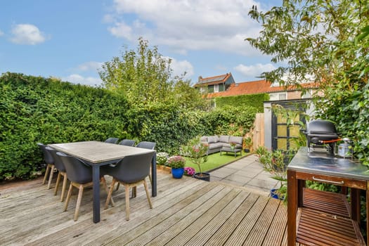 A beautifully arranged backyard garden featuring a dining table, lush greenery, and cozy seating. Perfect for outdoor gatherings and relaxation.