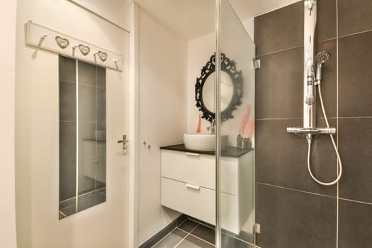 Stylish contemporary bathroom featuring sleek tiles, a minimalist shower, and elegant fixtures. The space highlights modern aesthetics and practicality.