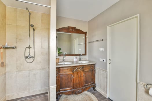 A beautifully designed modern bathroom featuring wood elements, dual sinks, and a spacious shower area, creating a serene and functional space.