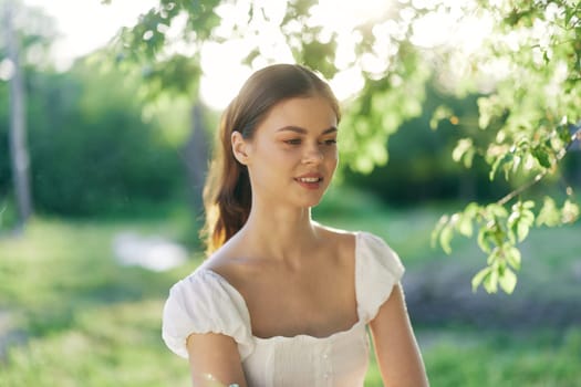 A serene young woman wearing a white dress with short sleeves, surrounded by lush greenery, radiating peaceful emotions and healthy living themes, ideal for lifestyle photography