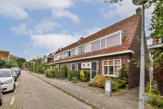 A picturesque view of a charming residential street lined with attractive houses, greenery, and a clear blue sky giving a peaceful suburban feel.