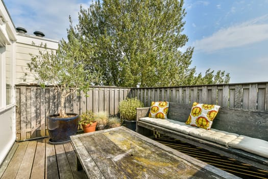 An inviting outdoor patio featuring comfortable seating, lush greenery, and a serene atmosphere perfect for relaxation or gatherings.