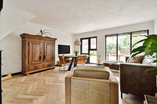A modern living room featuring stylish furniture, natural light, and decorative elements that create a comfortable and inviting atmosphere.