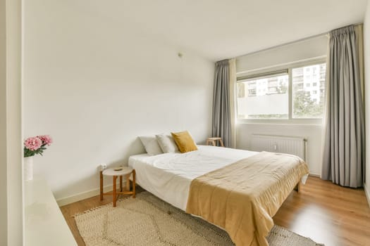 A clean, modern bedroom featuring a cozy bed with neutral tones, soft lighting, and minimal decor, creating a serene atmosphere for relaxation.