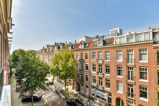 A picturesque view of a quaint European street featuring classic architecture and lush trees lining the sidewalk. Ideal for urban exploration enthusiasts.