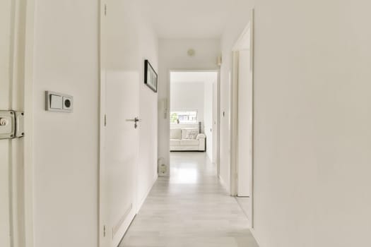 A spacious and well-lit hallway featuring clean lines and light-colored walls. The setup creates an inviting atmosphere with natural light flowing through.