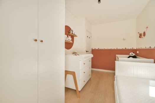 A bright and spacious nursery featuring minimalist decor with soft colors and natural light. Designed for comfort and style, ideal for a child's room.