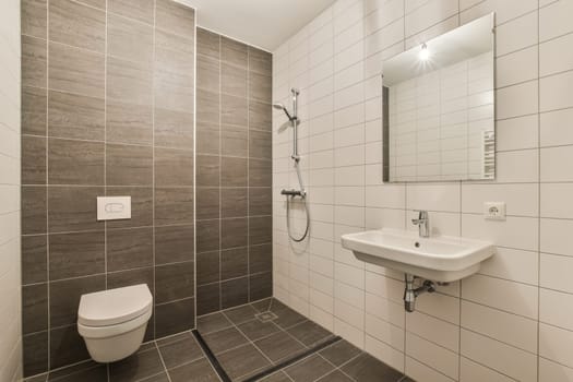 A sleek and contemporary bathroom showcasing a stylish shower area with elegant tiles and minimalistic fixtures, perfect for modern living.