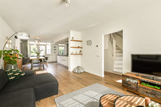 A stylish modern living room featuring comfortable furniture, bright decor, and an inviting atmosphere, perfect for relaxation and social gatherings.