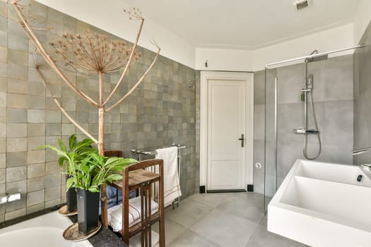 Featuring a minimalist aesthetic, this modern bathroom integrates natural elements like plants and sleek fixtures for a serene experience.