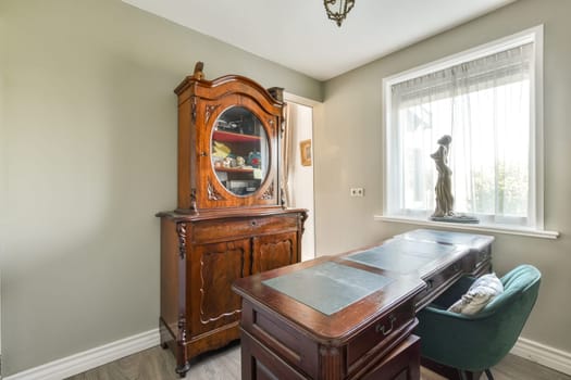 A beautifully styled interior featuring a classic wooden cabinet and a serene atmosphere, enhancing the elegance of the living space.