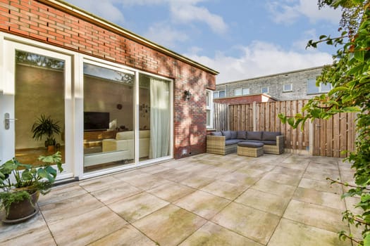 Bright and airy modern patio featuring a cozy seating area surrounded by greenery. Ideal for relaxation and entertaining outdoors.