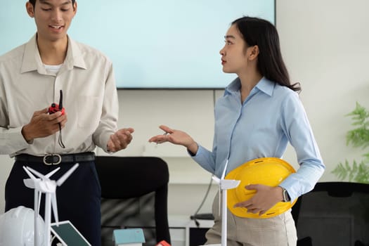 A diverse group of professionals engage in dynamic discussions around sustainability solutions while showcasing innovative practices and tools in a meeting.