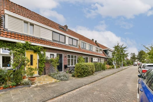 A picturesque residential street featuring well-kept homes adorned with vibrant flowers and lush foliage, creating a serene neighborhood atmosphere.