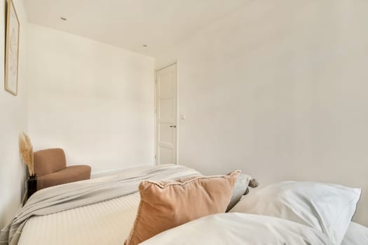 A serene and minimalist bedroom featuring soft textures and neutral colors, providing a peaceful and relaxing atmosphere for rest.