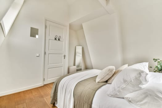 A serene minimalist bedroom featuring a clean design, light colors, and cozy bedding. The space exudes tranquility with natural light flooding through the windows.