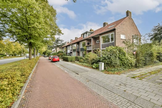 An inviting urban street scene lined with trees and residential buildings, showcasing a blend of nature and architecture.
