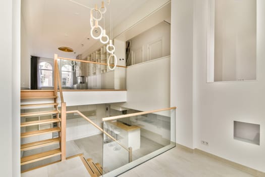 A sleek modern interior showcasing a minimalist staircase with glass railing and wooden accents, emphasizing simplicity and elegance in design.