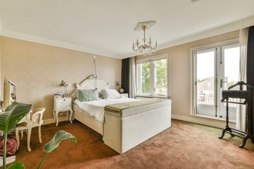 Spacious bedroom featuring a luxurious bed, natural light from windows, and stylish decor elements. A blend of comfort and beauty creates a serene atmosphere.