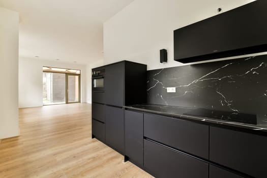 A stylish modern kitchen featuring elegant black cabinets and sophisticated design elements, perfect for contemporary living spaces.