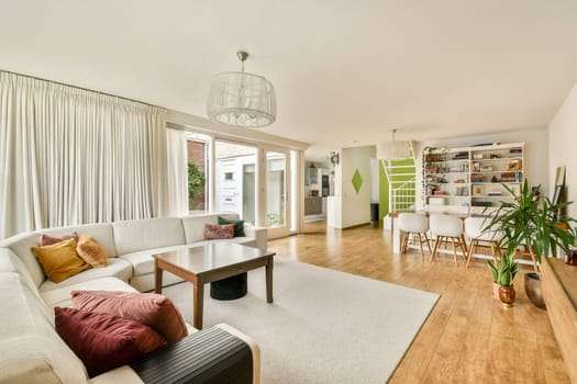 Bright and inviting modern living room with plush seating, light wood flooring, and stylish decor elements creating a warm atmosphere.