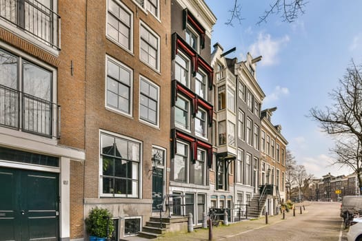 A picturesque street in Amsterdam featuring unique architectural styles and inviting façades, lined with trees and quaint details. Perfect for urban exploration.