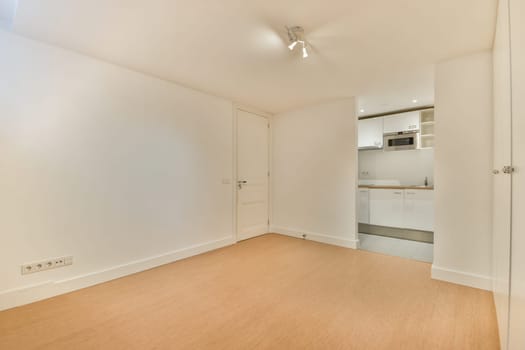 A bright and spacious indoor area featuring clean lines and contemporary design. The room showcases a minimalist aesthetic with neutral tones.