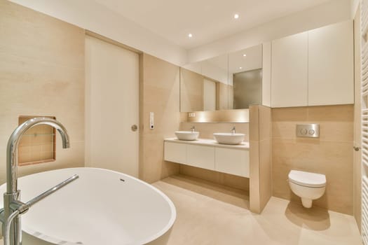 A contemporary bathroom featuring a sleek tub, double sinks, and clean lines. The neutral color palette enhances the minimalist aesthetic, promoting tranquility.