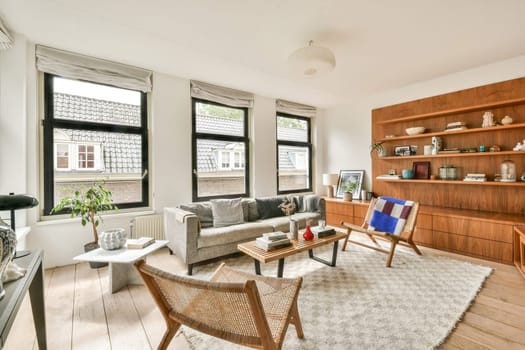 A cozy modern living room featuring large windows, stylish furniture, and elegant decor elements. Ambient lighting accentuates the inviting atmosphere.