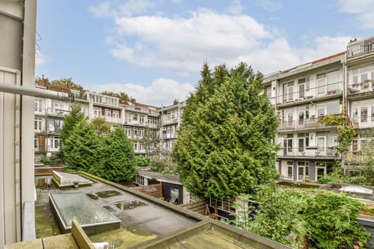 A picturesque urban courtyard featuring charming architecture, surrounded by verdant plants. The scene invites tranquility amidst city life.