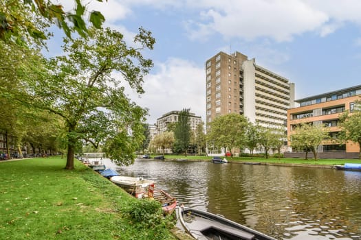 A scenic view of a serene urban waterway framed by lush greenery and diverse architectural styles, reflecting a harmonious balance between nature and city life.