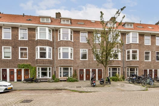 A picturesque urban street showcasing charming brick buildings, bicycles parked, and lush greenery. Ideal for capturing the essence of city life.