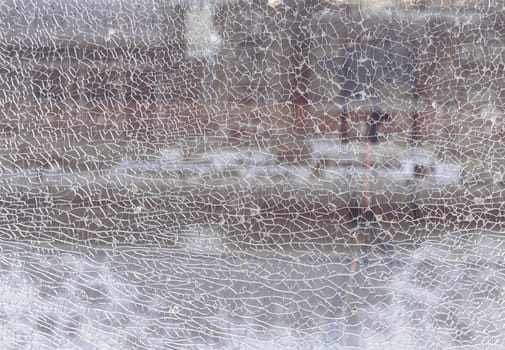 Newcastle, UK - Apr 11, 2025 - Texture of cracked broken glass cracked by impact. Detail of broken tempered glass pane too many small irregular shape pieces holding together, Cracks on the glass surface background, use it as your Wallpaper, Poster and Copy space, Selective focus.