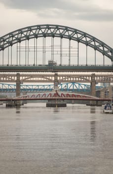 Newcastle, UK - Apr 12, 2025 - Stunning view of the Newcastle upon tyne with Tyne bridge, Swing bridge and The High level bridge spanning the River Tyne connecting Newcastle upon tyne and Gateshead in North East England before sunset. use it as your Wallpaper, Poster and Copy space, Selective focus.