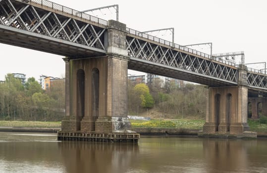 Newcastle, UK - Apr 12, 2025 - A view of The King Edward VII Bridge (Railway viaduct) is a railway bridge spanning the River Tyne between Newcastle upon tyne and Gateshead in the North East of England. King Edward VII Bridge has been described as “Britain’s last great railway bridge”, use it as your Wallpaper, Poster and Space for text, Selective focus.