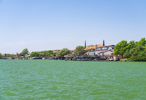 Luxury homes line the lakeshore with boat docks on LBJ Lake in Horseshoe Bay Texas