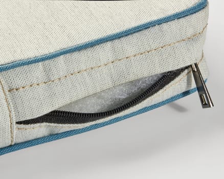 Open zipper on a cushion revealing foam filling, highlighting quality and easy maintenance