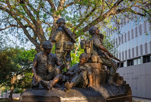 Austin, TX - 10 April 2025: Vietnam Veterans Memorial statue in bronze by State Capitol building in Texas