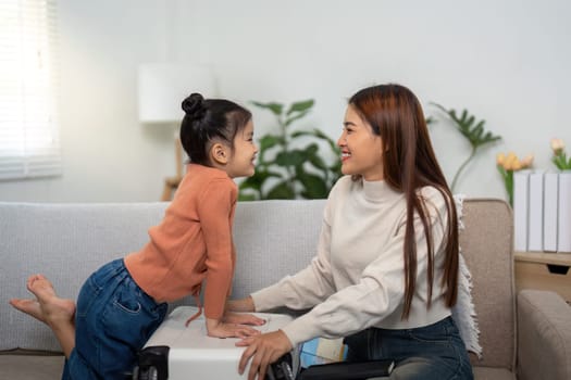 Sharing smiles and excitement, a mother and daughter bond over the process of packing, emphasizing the joy of planning their next adventure.