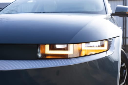 Car flashing light with blinking indicator. Emergency flashing car light lamp, warning sign. LED Headlight of a car Shining. Led light of a car shining bright. Nobody around to help