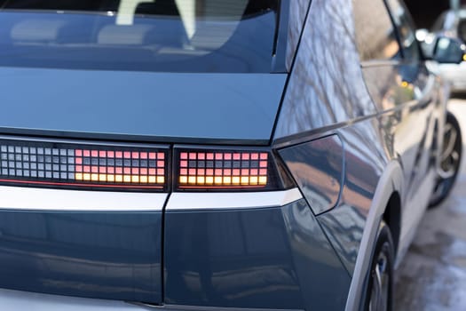 Car taillight. LED red taillight. Closeup tail light of a modern car. Rear light of a car. Rear lamp signals for turning car on street. Signal function to keep them distance. Trunk closeup.