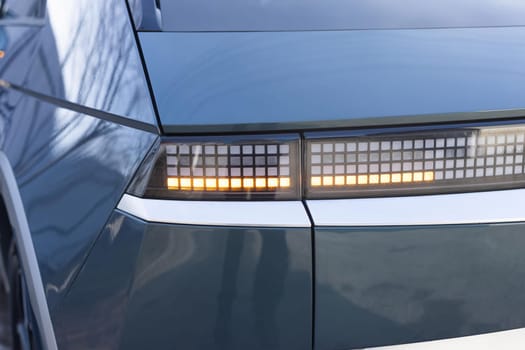 Emergency flashing car rear light lamp. Car emergency light signal, warning sign. Nobody around to help. Tail light signals for turning a car on the street. Car on the road with tail left yellow light