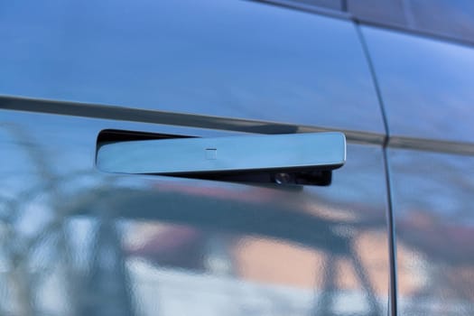 Car door handle with unlock button. Keyless entry car door handle with touch sensor. Access button. Modern car. Car security concept.