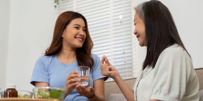 A happy moment where a mother shares nutrients info with her senior, facilitating an important conversation about health and wellness.