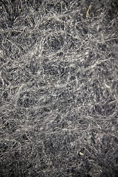 Close-up view of fabric fibers under a microscope, revealing intricate texture and structural complexity.