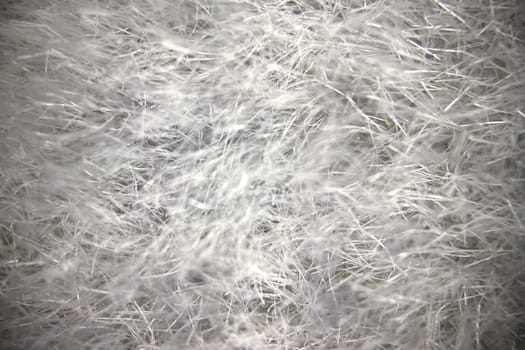 Close-up view of fabric fibers under a microscope, revealing intricate texture and structural complexity.