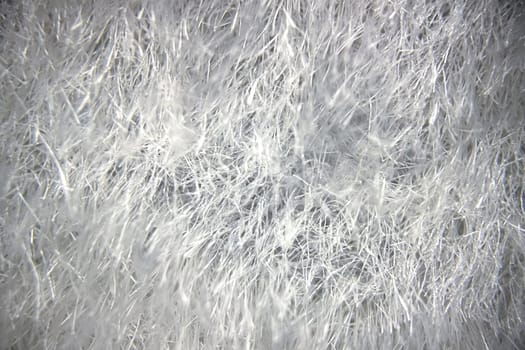 Close-up view of fabric fibers under a microscope, revealing intricate texture and structural complexity.